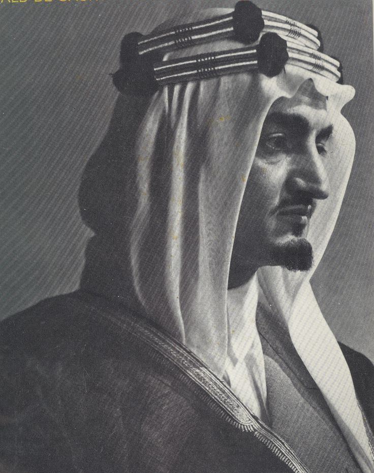 King Faisal of Saudi Arabia with a serious face and wearing traditional clothing for men.