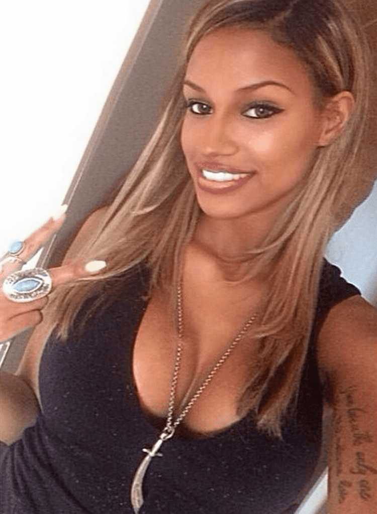 Fanny Neguesha smiles while capturing herself posing a peace sign