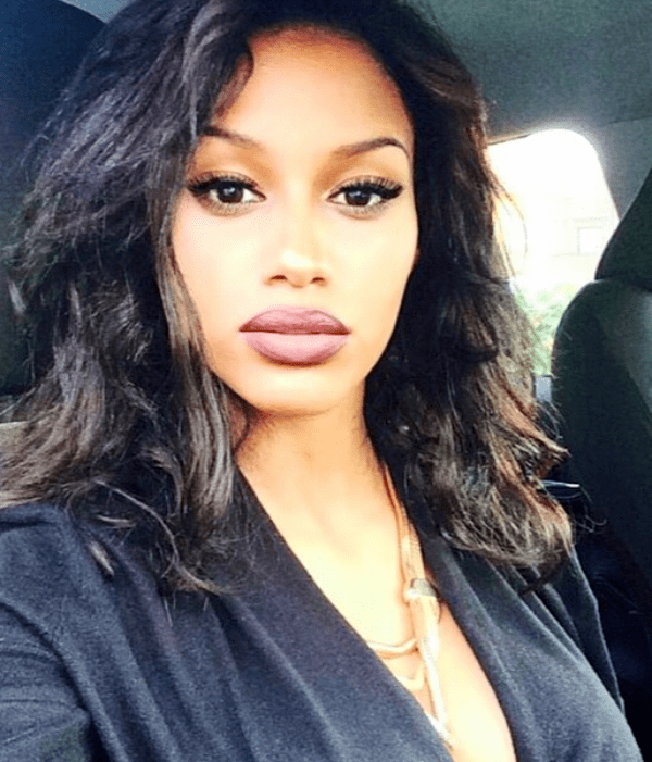 Fanny Neguesha capturing herself inside a car wearing a black shirt and necklaces