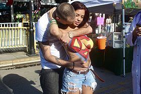 Man hugging a woman with her body painted at Fantasy Fest
