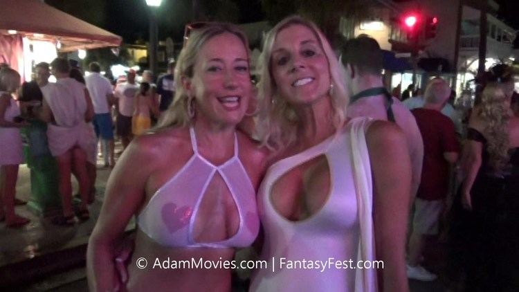 Two women at Fantasy Fest wearing a white swimsuit