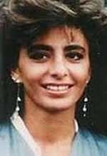 Young Farahnaz Pahlavi wearing earrings and blue blouse while smiling