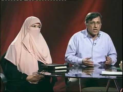 A lady wearing a black abaya and a light pink hijab and beside her is a gentleman wearing eyeglasses and powder blue long sleeves.