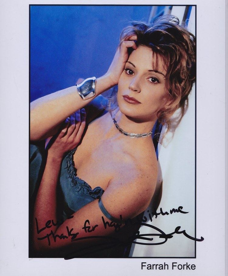 Farrah Forke hand on her head while wearing a blue sleeveless top, necklace, bracelet, and an autograph on the bottom part