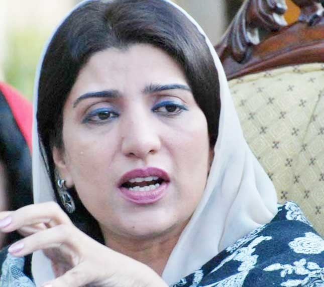 Farzana Raja wearing earrings and scarf while talking.