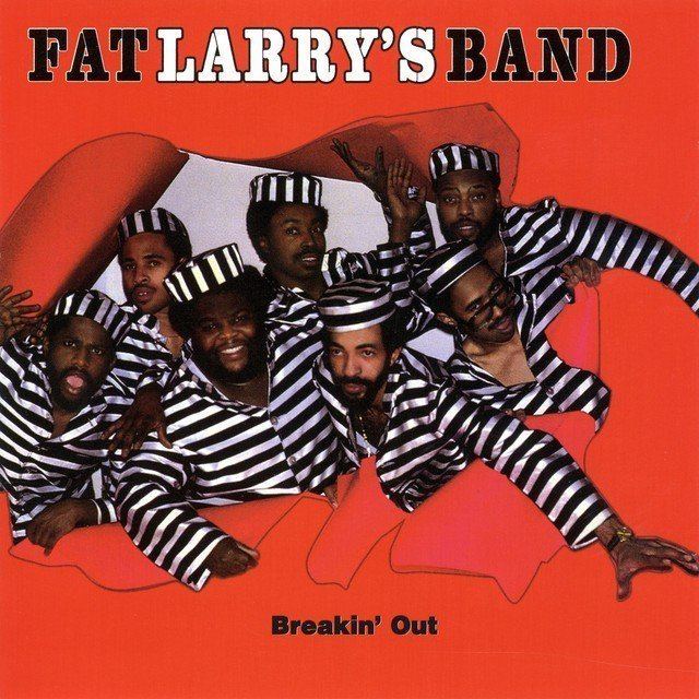Fat Larry's Band members posing while wearing a black and white striped long sleeve and cap for the Breakin' Out album cover