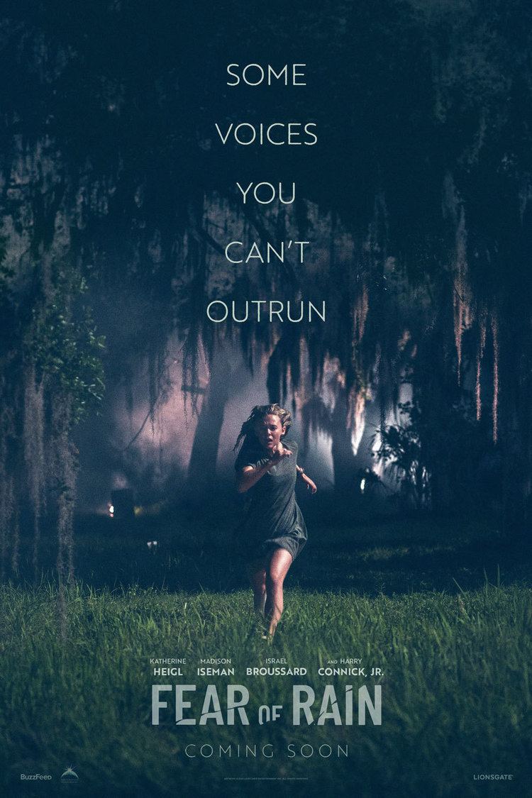 A poster of the 2021 movie "Fear of Rain" featuring Madison Iseman running in the forest during the night and looking terrified