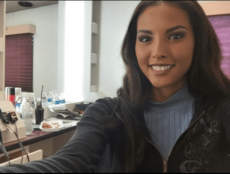 Felisha Cooper smiling and wearing black jacket and gray turtle neck