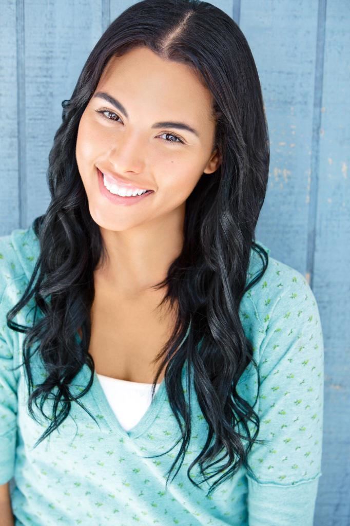 Felisha Cooper smiling while wearing blue and green blouse