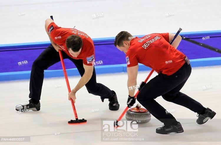 Stock Photo: The German curler Felix Schulze (L) and Christopher Bartsch play during the game for the qualification for the olympics at the Arena in Fuessen, Germany.
