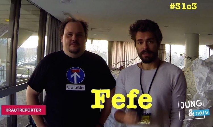 Felix von Leitner, otherwise known as Fefe, featured in a TV Show with a reporter wearing a black shirt.