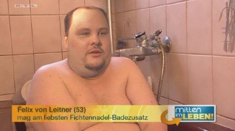 Felix von Leitner talking while being interviewed inside a bathroom.