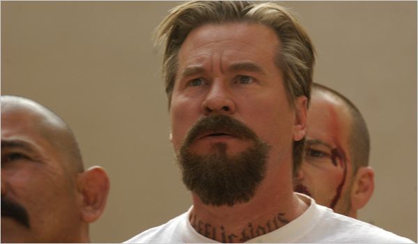 Val Kilmer as John Smith looking at something and wearing a white shirt in a scene from the movie Felon, 2008.