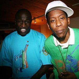 Shawn of Field Mob wearing a white cap and green polo shirt while Smoke wearing a blue printed t-shirt