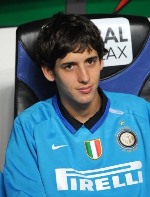 Filippo Mancini smiling while sitting on a black and blue chair and wearing a blue sweatshirt