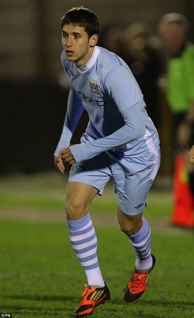 Filippo Mancini playing football while wearing a white and blue uniform