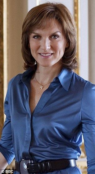 Fiona Bruce wearing a necklace and a blue dress with a black belt.