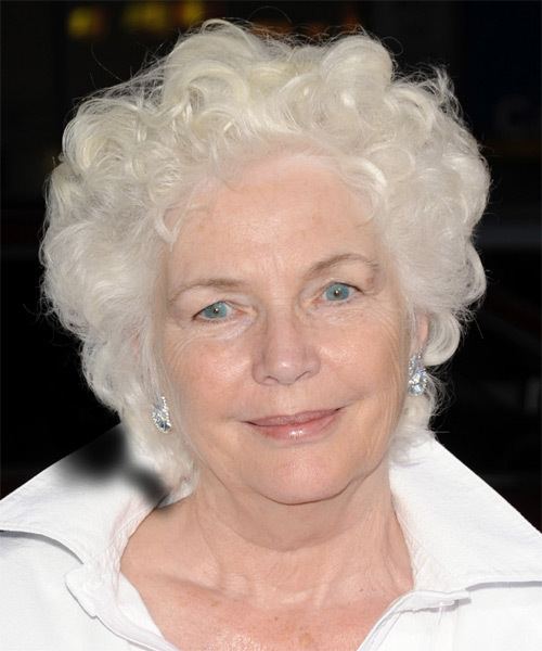Fionnula Flanagan smiling closed mouth and wearing a white dress.