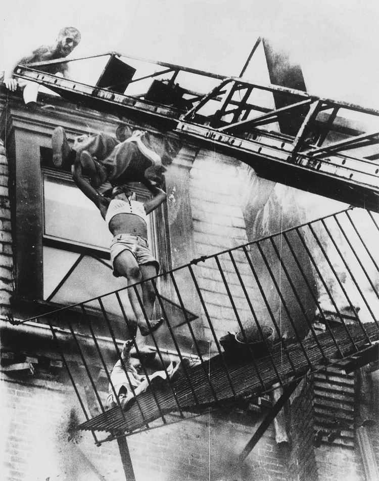 Diana Bryant and her 2-year-old goddaughter Tiare Jones falling from the collapsed fire escape of a burning apartment building