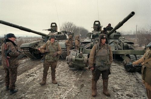 Russian troops near Grozny with two tanks behind them during the Chechen War