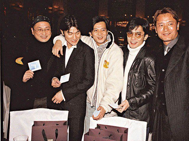 Members of Five Tiger Generals of TVB, Andy Lau, Kent Tong, Felix Wong, Tony Leung Chiu-wai, and Michael Miu are all smiling. Andy wearing a black coat over a black shirt, Kent wearing a black coat over a white shirt, Felix wearing a white jacket, Tony wearing sunglasses, and a black leather jacket, and Michael wearing a black striped coat over a black shirt.