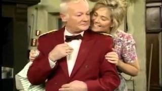 Fleur Bennett smiling while hugging John Inman in a scene from the 1992 tv series Are You Being Served? Again!