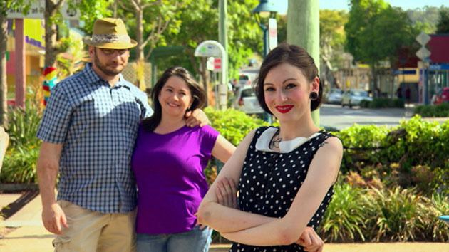 A scene of a man and two women smiling together in the street in reality tv series Formal Wars (2013)