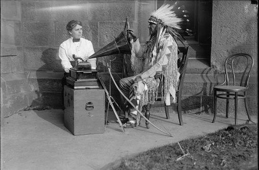 Frances Densmore Mountain Chief of Montana Blackfeet listening to
