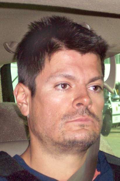 Francisco Javier Arellano Félix with a serious face inside a car, and with beard and mustache.