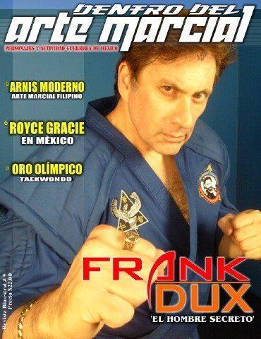 Frank Dux on a magazine cover while wearing blue dobok and gold bracelet and ring