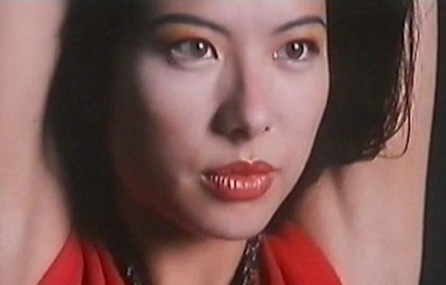 Françoise Yip wearing red top while her arms upward