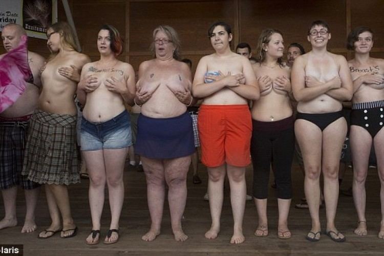 Women and men gathered at the beach in New Hampshire to take off their tops