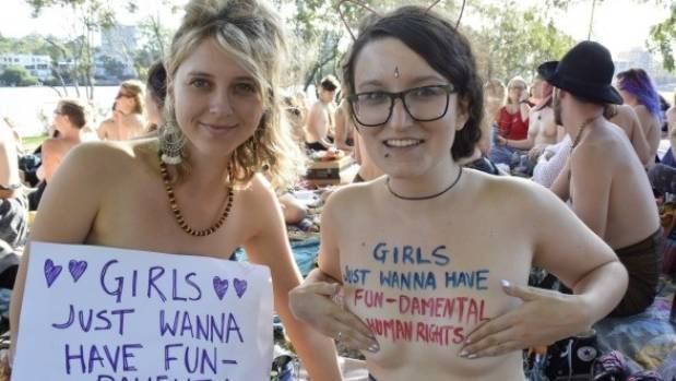 Two topless women engaged in the “Free the Nipple” (campaign)