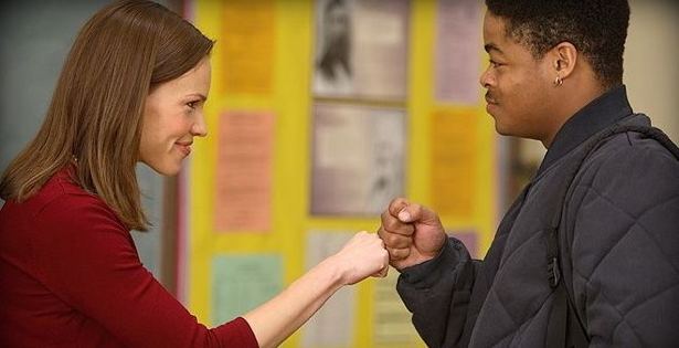 Freedom at the Edge movie scenes Hillary Swank portraying Erin Gruwell fist bumps with a student in Freedom Writers Paramount Pictures 