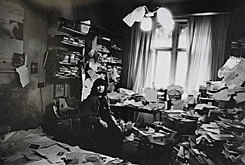 Friederike Mayröcker inside a messy room
