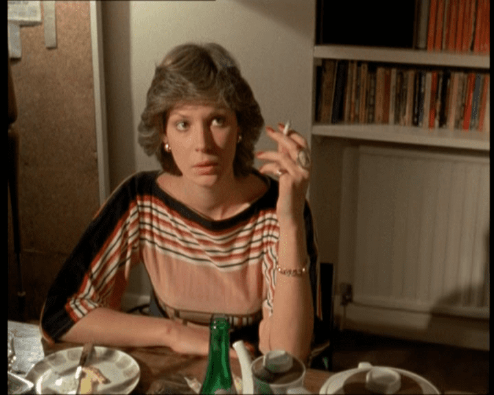 Gail Grainger holding a cigarette and wearing a striped blouse