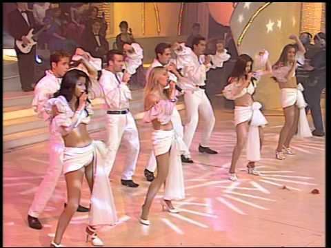 Garibaldi group performing while the girls are wearing a white top and white skirt and the boys are wearing white long sleeves and pants