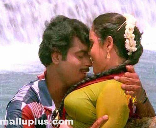 Geetha being held by Rajkumar in a scene from the 1986 movie Kshamichu Ennoru Vaakku