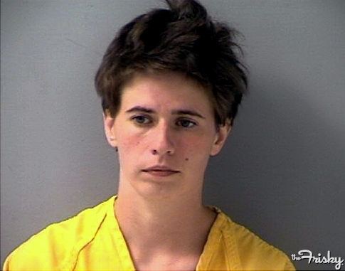 A mugshot of Gemma Barker during her arrest with short boyish hair and wearing a yellow shirt.