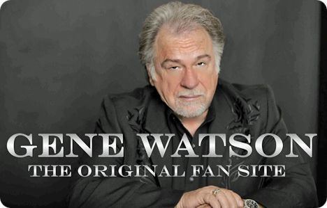 Gene Watson with mustache and beard while wearing a black coat and black long sleeves