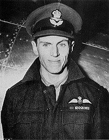 George Beurling smiling and wearing a cap and a coat