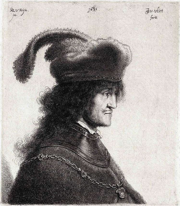 George I Rákóczi is serious with different words above him, has long black curly hair, a beard, and a mustache, he is wearing a black hat with beads, a chain-like necklace, and a black coat.