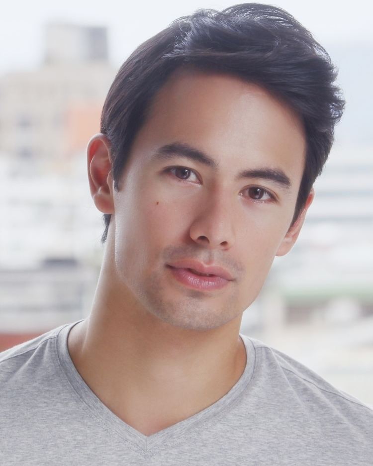 George Young wearing a gray t-shirt