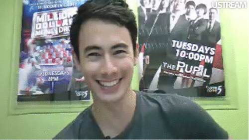 George Young with wacky poses while wearing gray t-shirt