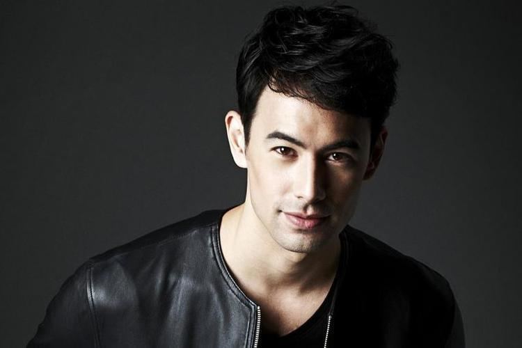 George Young smiling while wearing a black leather jacket