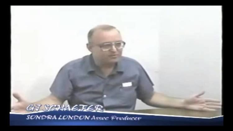 Gerard John Schaefer wearing eyeglasses and a blue polo shirt during an interview inside a cell.
