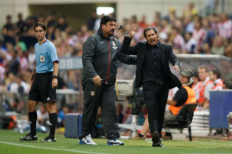 Diego Pablo Simeone (3rd from the left) of Atletico de Madrid protests a referee's decision (1st from the left) as assistant coach while German Burgos (2nd from left) tries to calm him during the Spanish Super Cup first leg match between Club Atletico de Madrid and FC Barcelona at Vicente Calderon Stadium on August 21, 2013, in Madrid, Spain.