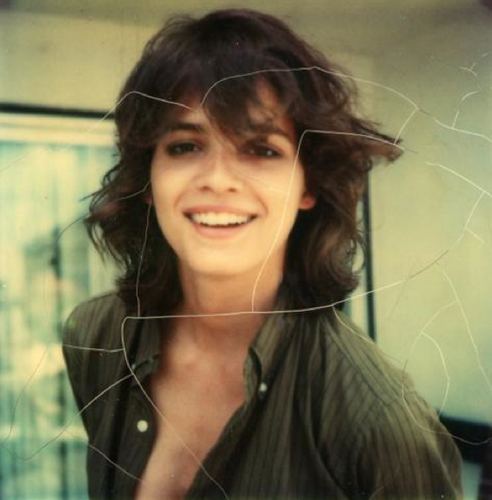 Gia Carangi smiling and wearing green striped long sleeves