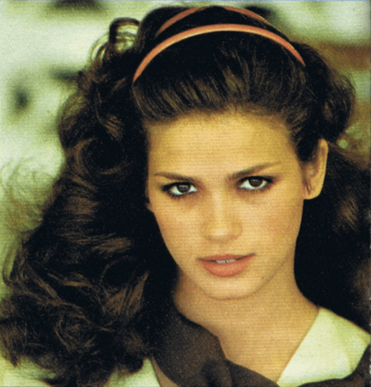Gia Carangi with curly hair and fierce look