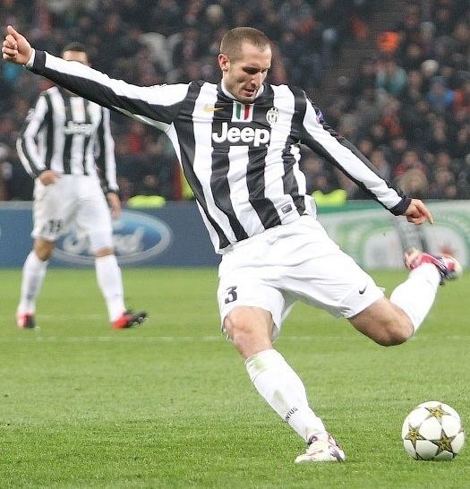 Giorgio Chiellini playing football while wearing a black and white jersey